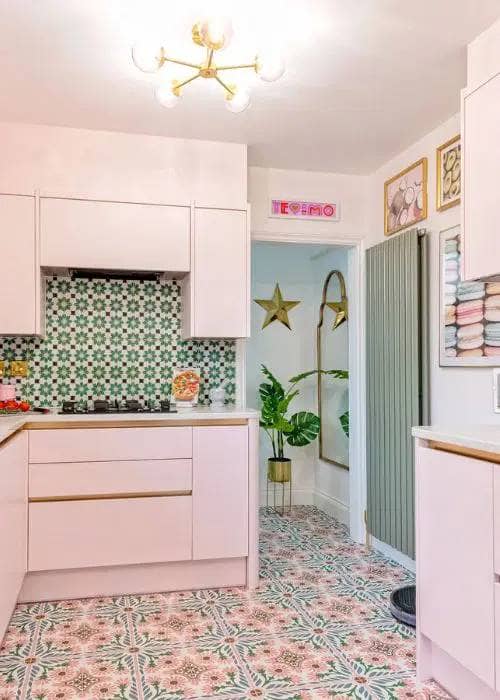 a green vertical radiator in a pink kitchen space - showing how versatile a vertical radiator can be 