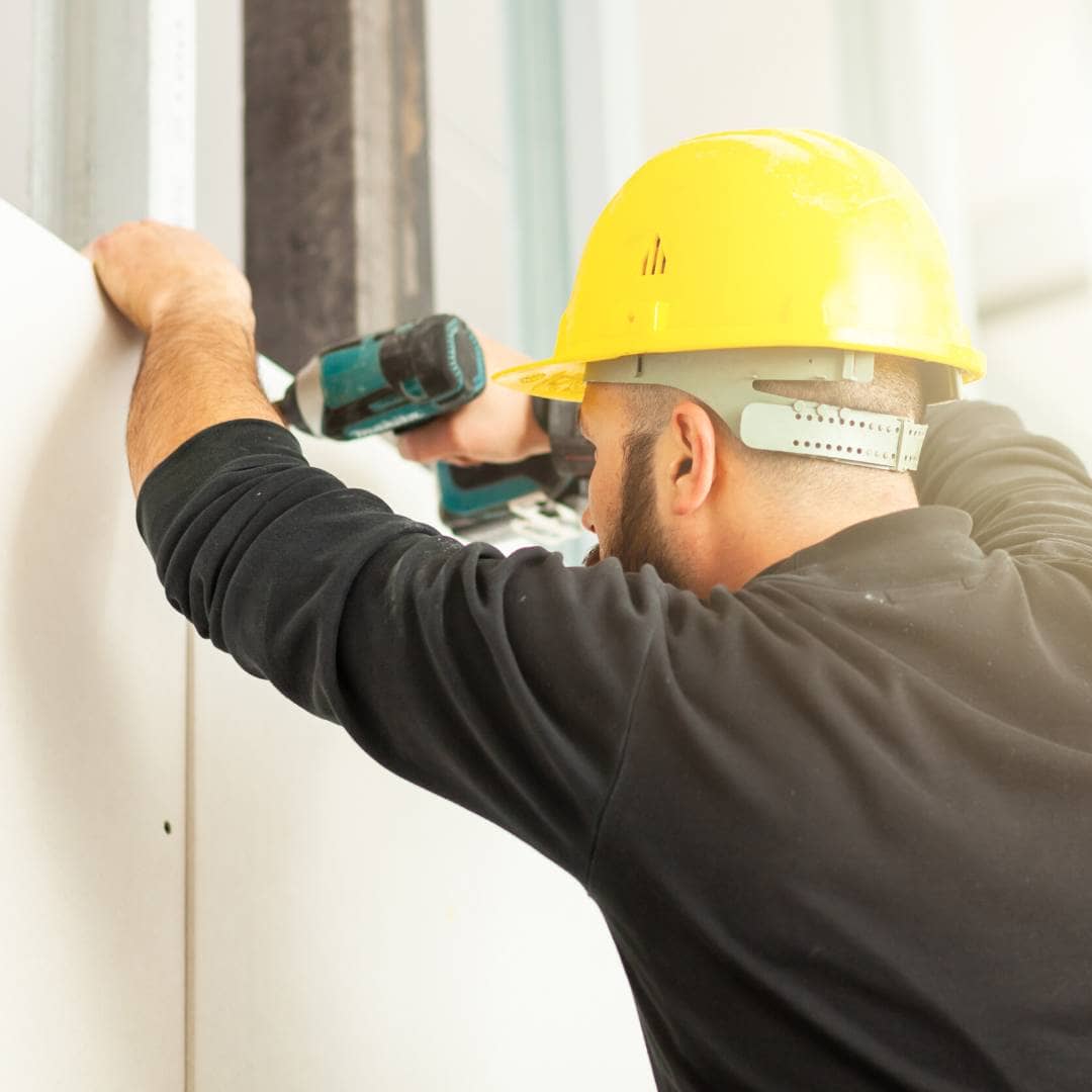 man building a stud wall