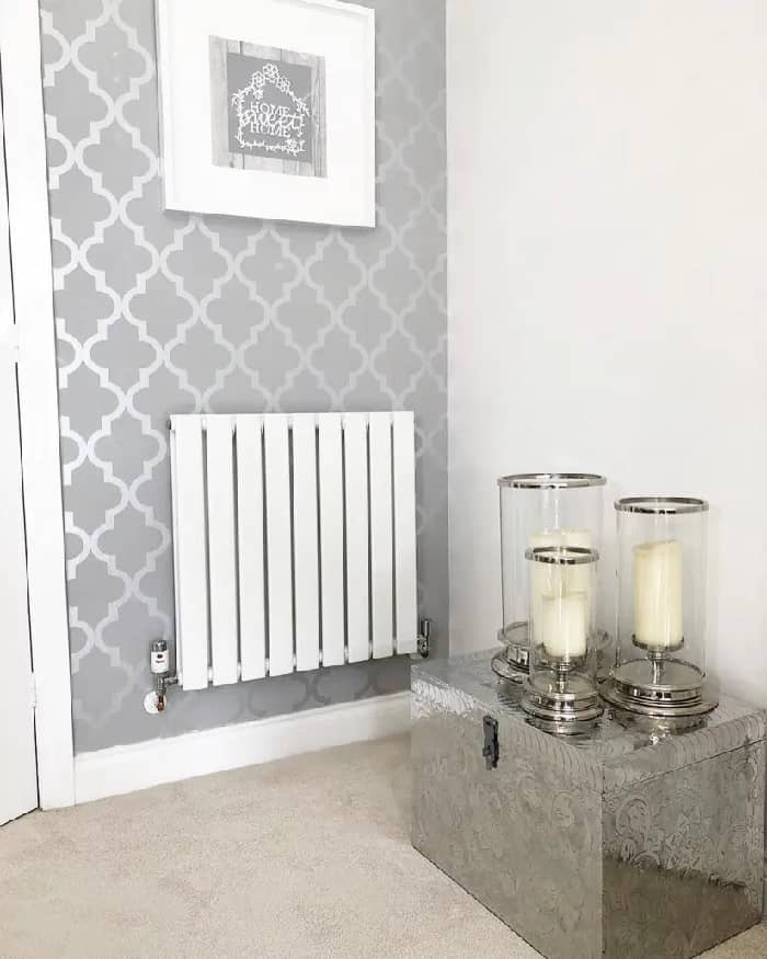 A white Milano Alpha designer radiator on a grey wall.