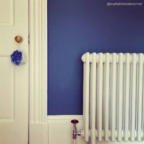1 white column radiator on a classic blue wall