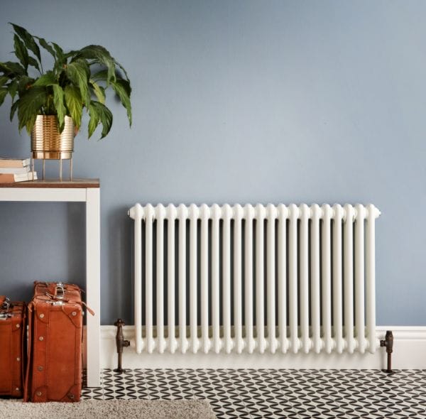 a white windsor radiator in a hallway on a blue background