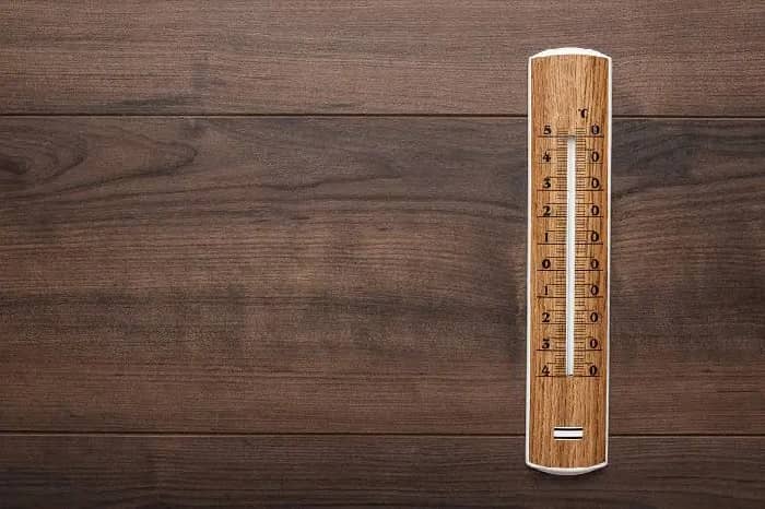 woodern thermometer on wooden surface