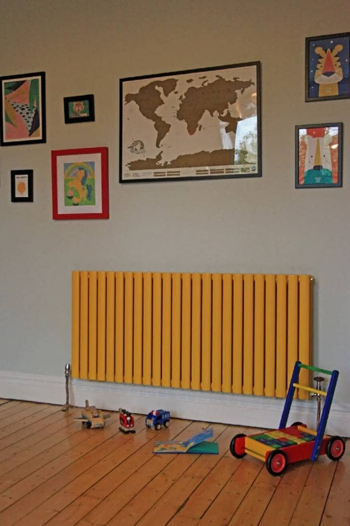 Fresh Start Living - Colourful Rainbow Childrens Bedroom 6 yellow radiator in a playroom with toys on the floor